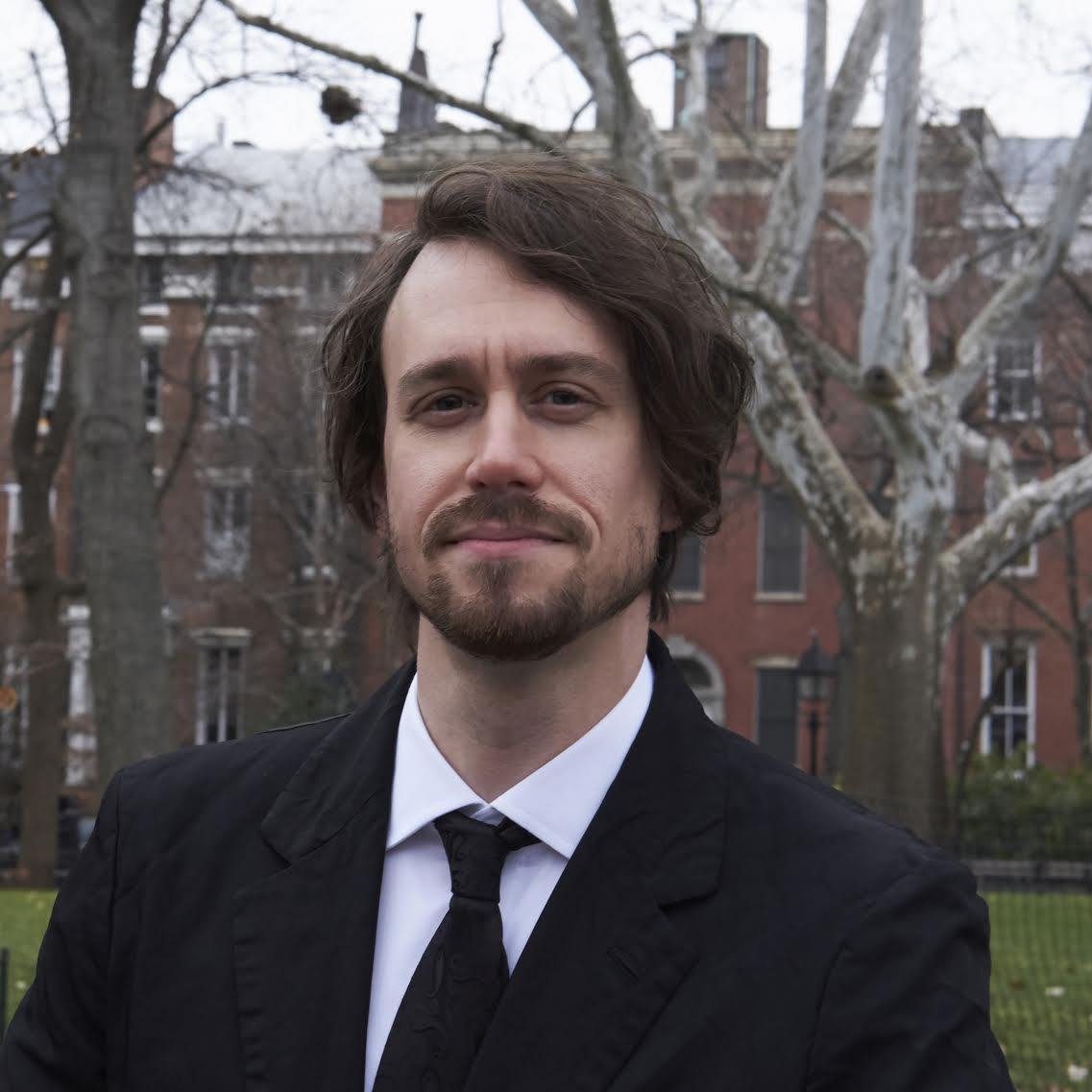 A portrait photo of Alexander Beznes standing in Washington Square Park.